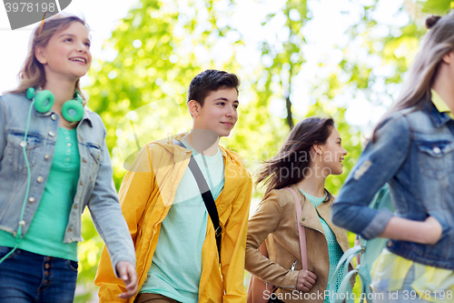 Image of group of happy teenage students walking outdoors