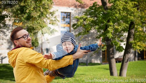 Image of father with son playing and having fun outdoors