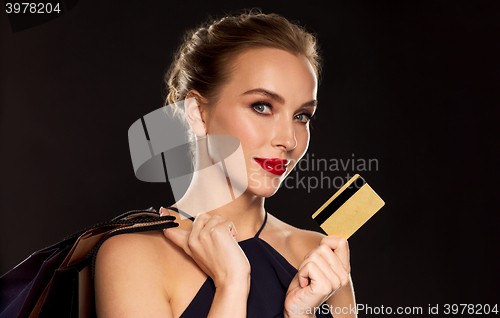 Image of woman with credit card and shopping bags