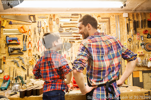 Image of happy father and little son workshop