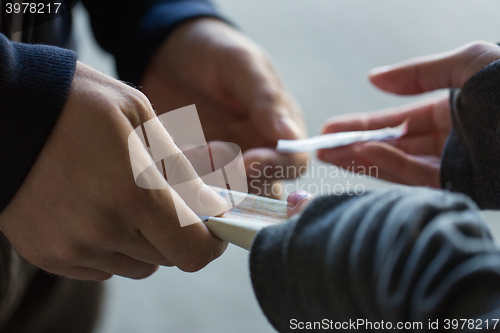 Image of close up of addict buying dose from drug dealer