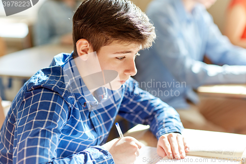 Image of group of students with books writing school test