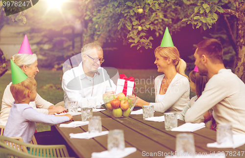 Image of happy family having holiday dinner outdoors