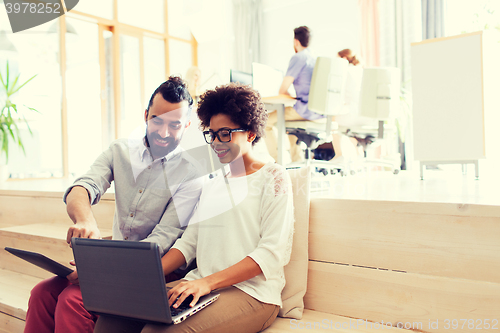 Image of creative team with laptop and tablet pc at office