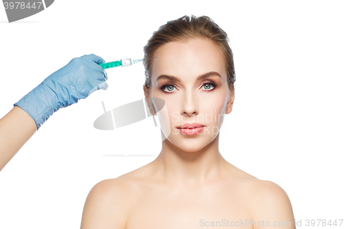 Image of woman face and hand with syringe making injection