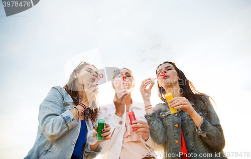 Image of young women or girls blowing bubbles outdoors