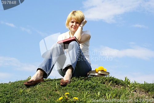 Image of female student outdoor on green grass