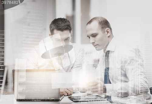 Image of two businessmen having discussion in office