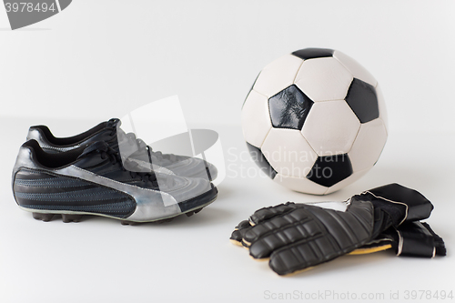 Image of close up of goalkeeper gloves, ball, soccer boots