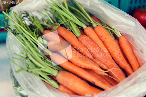 Image of close up of carrot in plastic bag at street market