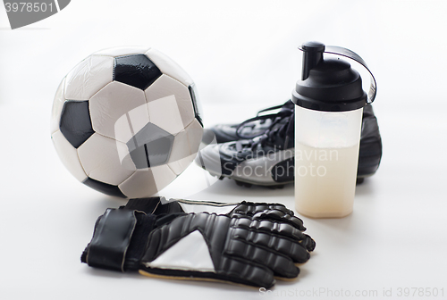 Image of close up of football boots, gloves and bottle