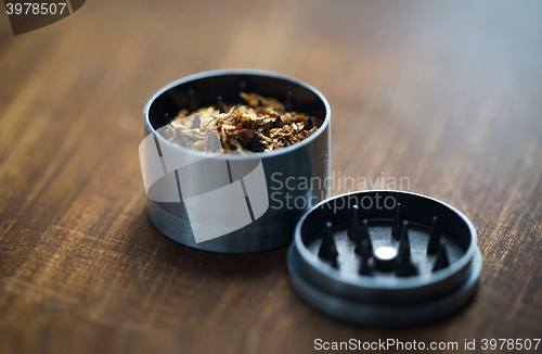 Image of close up of marijuana or tobacco and herb grinder