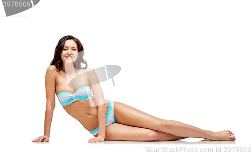 Image of happy young woman sunbathing in bikini swimsuit