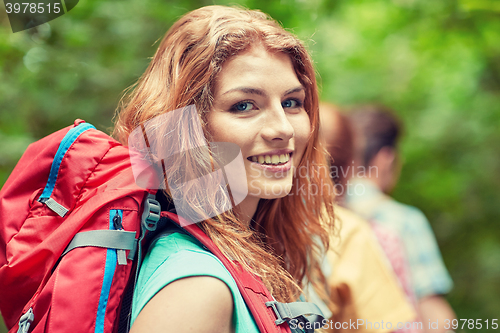 Image of group of smiling friends with backpacks hiking