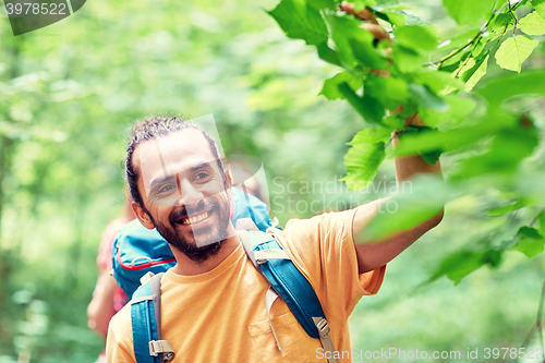 Image of group of smiling friends with backpacks hiking