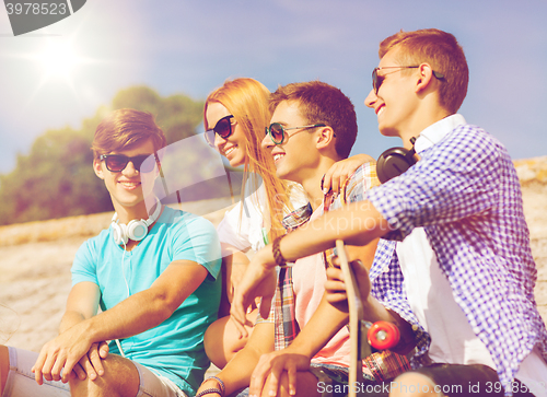 Image of group of smiling friends sitting on city street