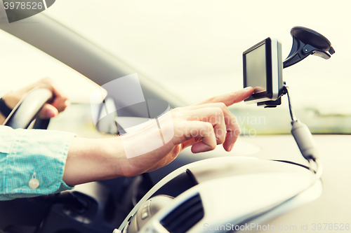 Image of close up of man with gps navigator driving car