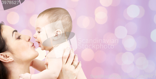 Image of happy mother kissing adorable baby