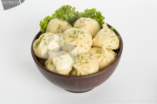 Image of khinkali cooked on a ceramic plate