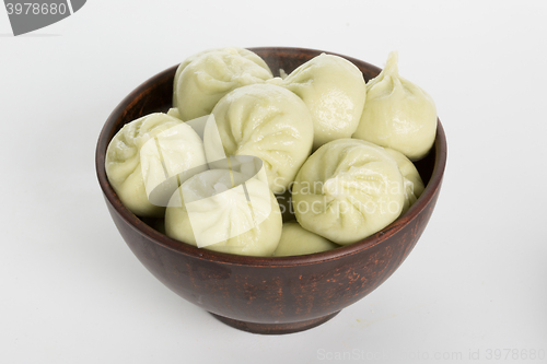 Image of khinkali cooked on a ceramic plate