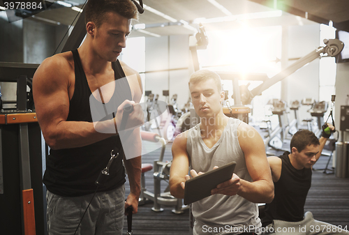 Image of men exercising on gym machine