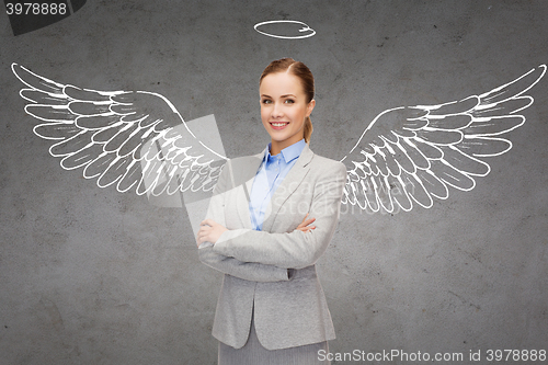 Image of happy businesswoman with angel wings and nimbus