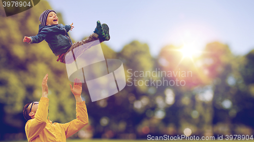 Image of father with son playing and having fun outdoors