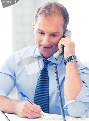 Image of handsome businessman talking on the phone