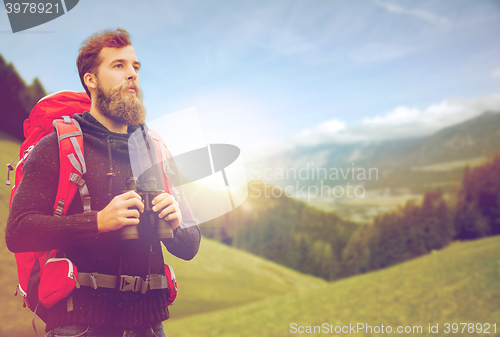 Image of man with backpack and binocular outdoors