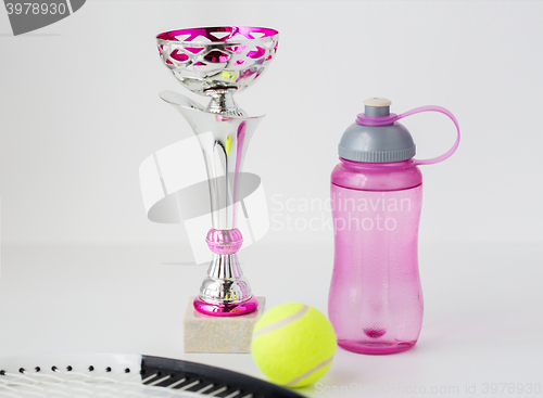 Image of close up of tennis racket, ball, cup and bottle