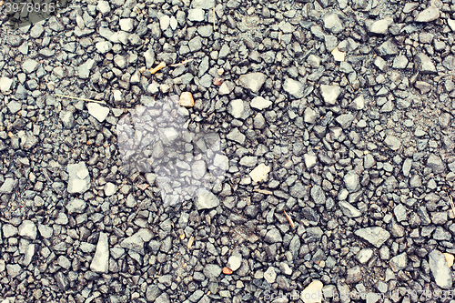 Image of close up of gray macadam stones on ground
