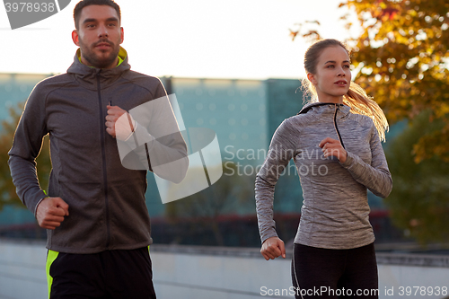 Image of couple running outdoors