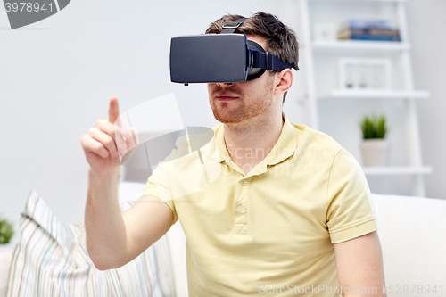 Image of young man in virtual reality headset or 3d glasses