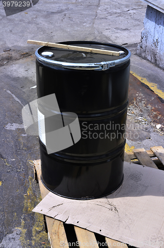 Image of Black metal barrel of combustive-lubricating chemicals 