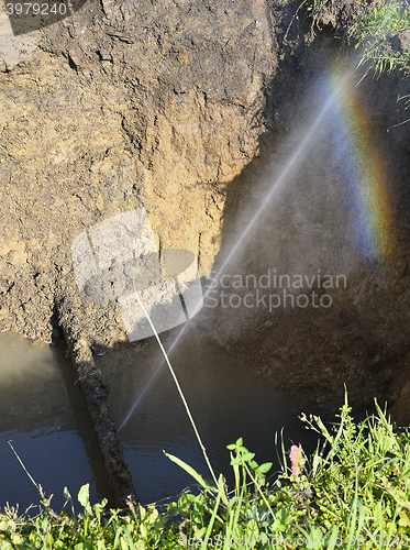 Image of The water jet in the form of leakage in the damaged metal pipe at the production site