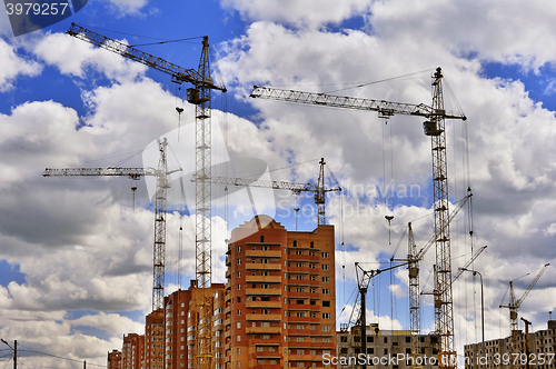 Image of  Construction site with cranes on sky background