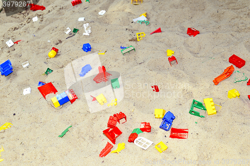 Image of Children's sandbox with toys scattered