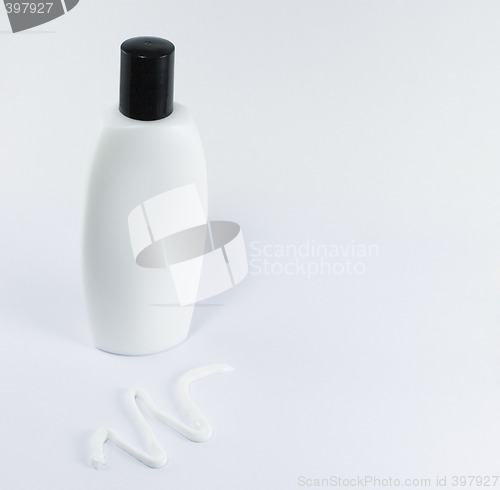 Image of cream and white bottle