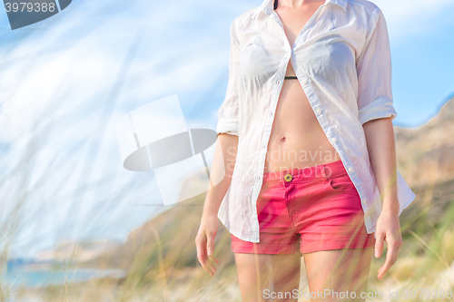 Image of Relaxed woman in white shirt enjoying in nature.