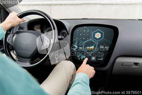 Image of close up of man driving car with diagram on screen