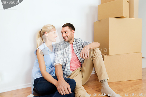 Image of couple with cardboard boxes moving to new home