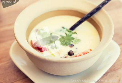 Image of bowl of creamy soup with shrimps on table