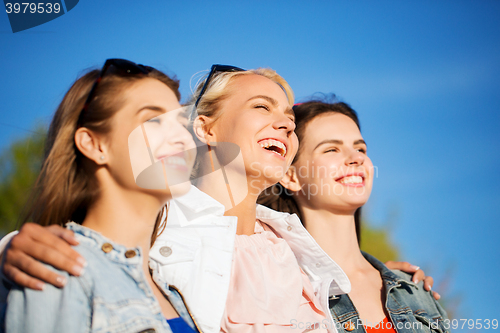 Image of happy women or teenage girls hugging outdoors