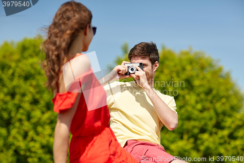 Image of happy couple with camera photographing
