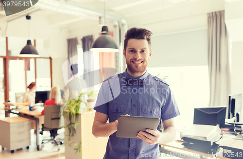 Image of happy creative male office worker with tablet pc