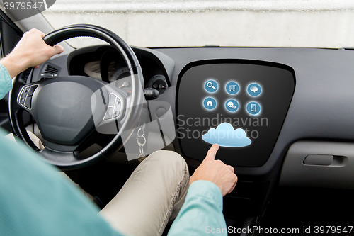 Image of close up of man driving car with menu on computer