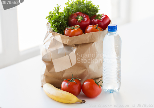 Image of close up of bag with friuts, vegetables and water