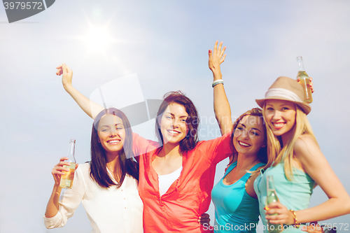 Image of girls with drinks on the beach