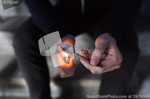 Image of close up of addict preparing crack cocaine drug