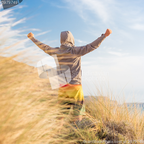 Image of Sporty active man enjoying beauty of nature.